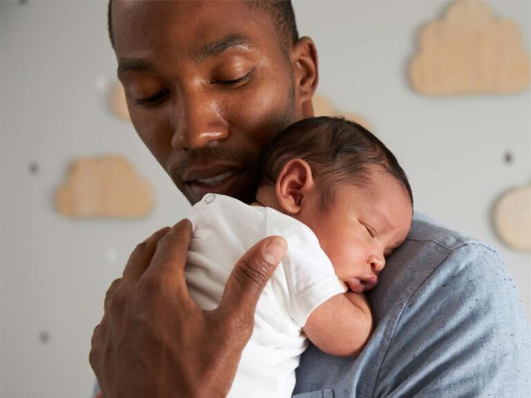 Father holding newborn baby