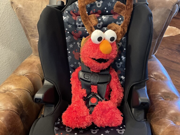 Elmo in a car seat
